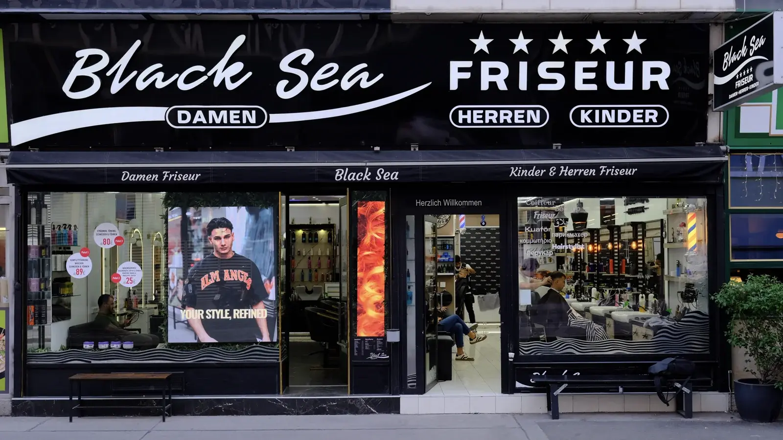 Storefront of Black Sea Friseur, location 1, with illuminated sign in Vienna 1030